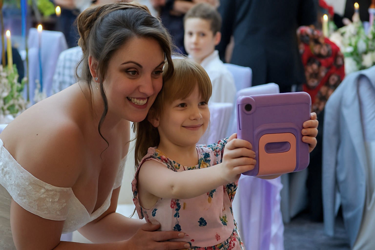 Bride and flower girl take a selfie at the white hart inn lydgate